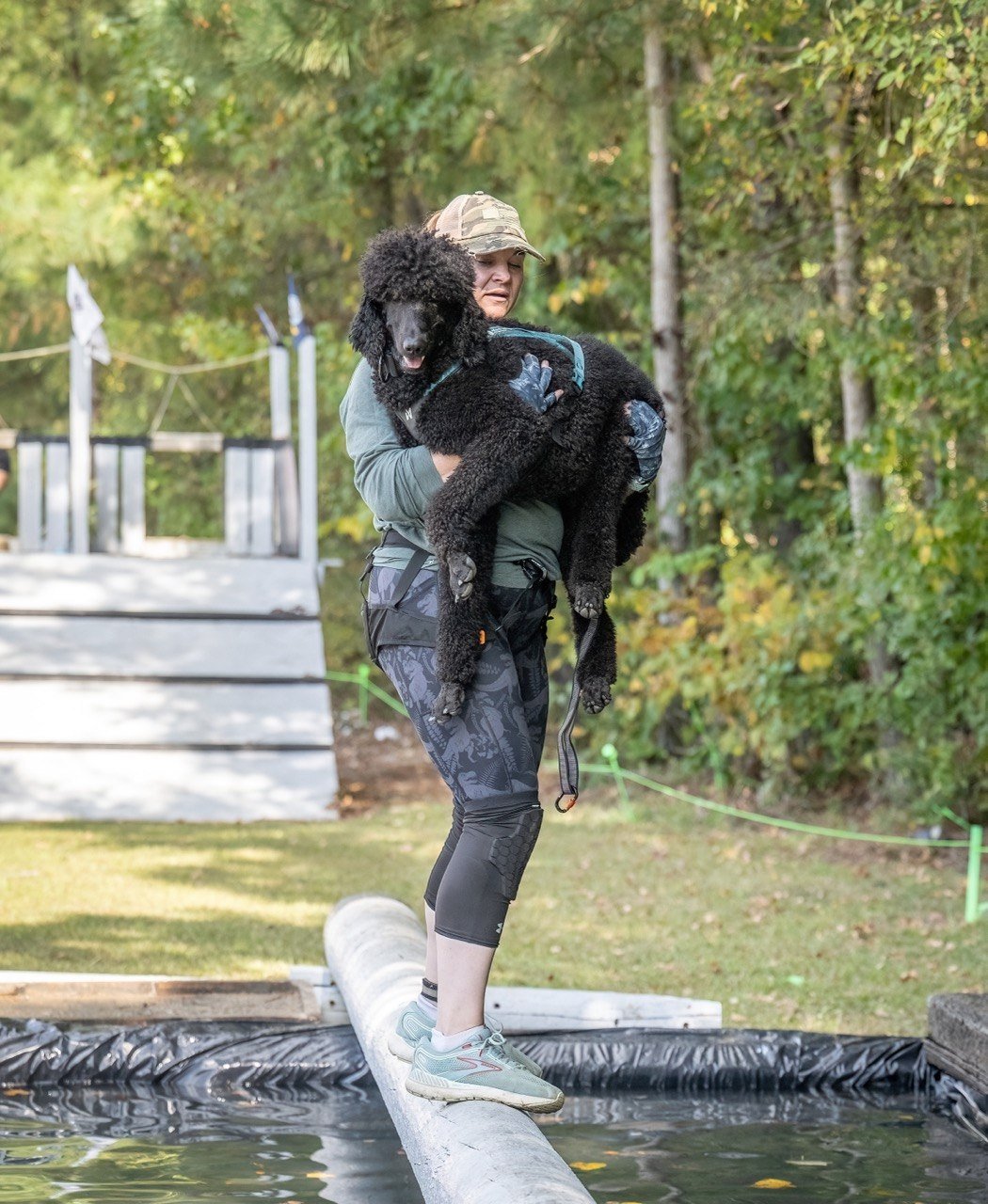 Abigail and Enzo at One World, log over water